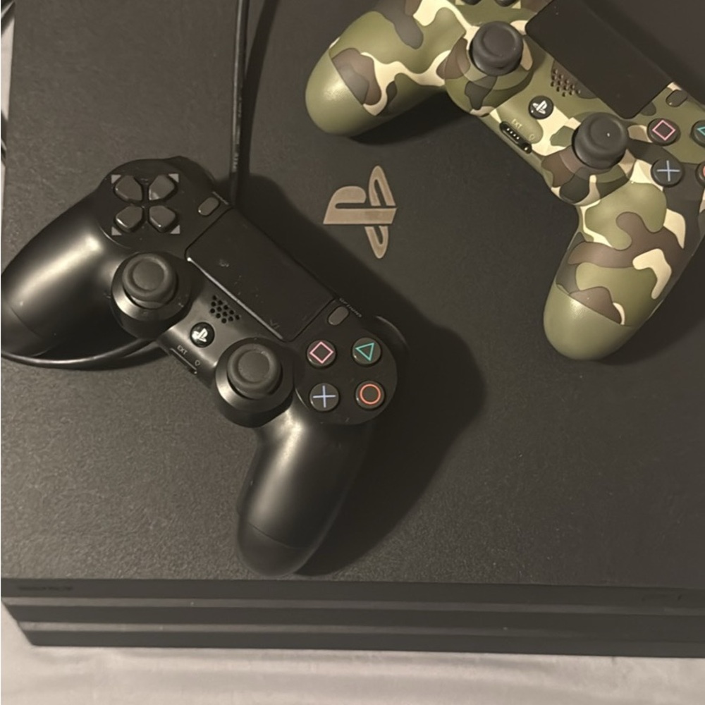 Sony Console with Black and Camouflage Controllers